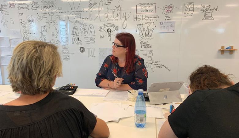 Three women in a class about how to do visual scribing.