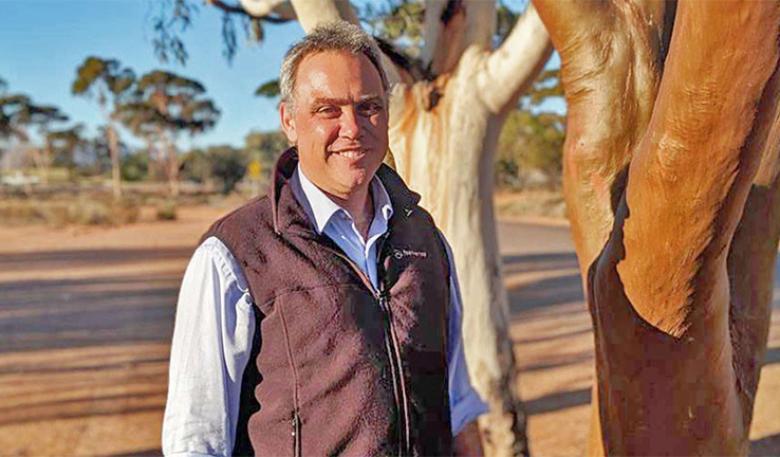 Shane Holland stands next to a gum tree near Spear Creek