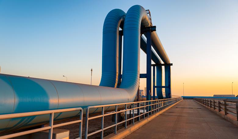 Image of blue pipes going to an oil refinery