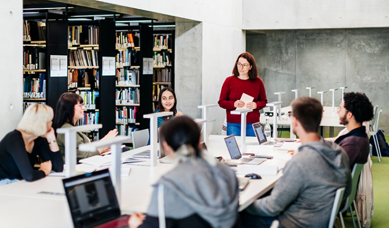 Image of a group of people working together in a seminar at a library.