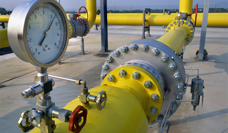 Manometer on yellow pipes in a gas distribution station