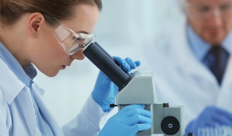 Female scientist using a microscope in a laboratory