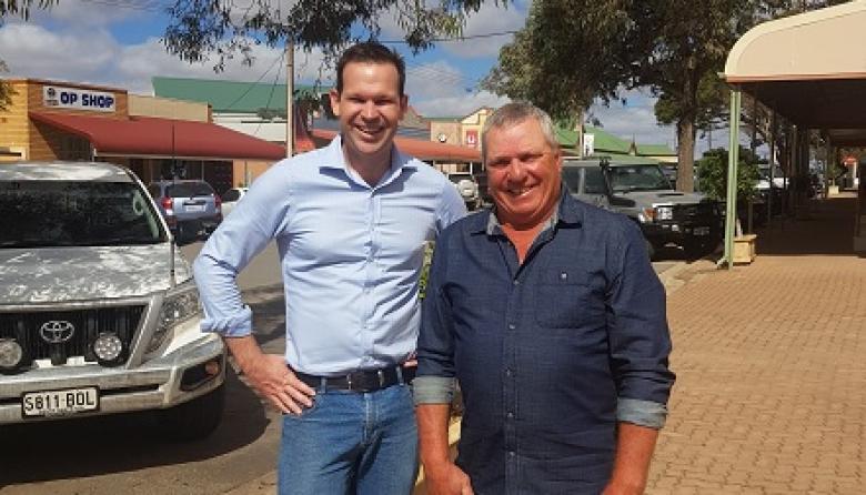 Minister Matt Canavan standing in a street in Kimba with a local resident.