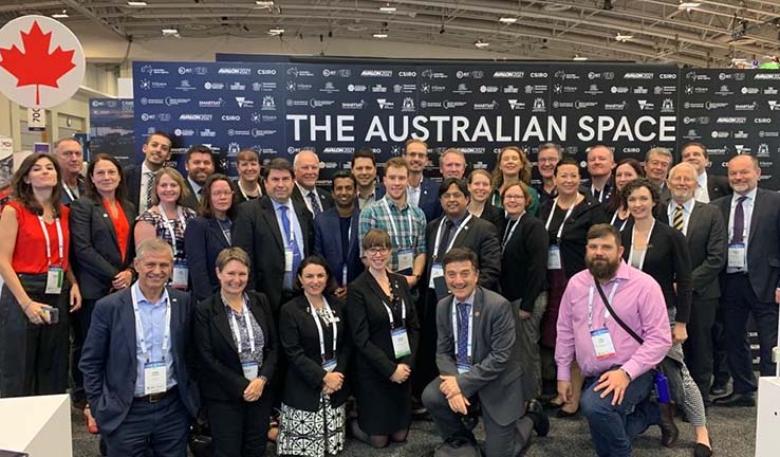 Team Australia at the 70th International Astronautical Congress A group of people stand in front of a wall that reads 'The Australian Space'