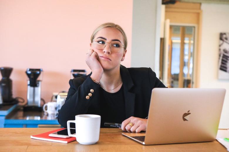 Photo of an uninspired woman in an online meeting