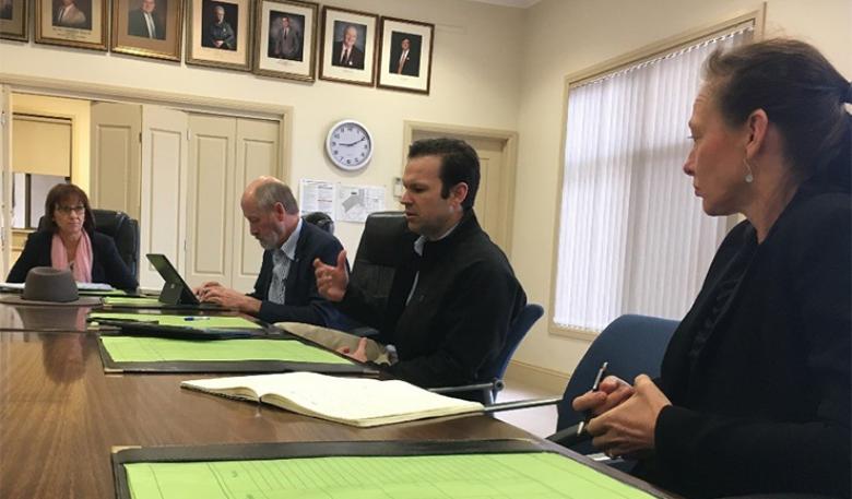 Minister Matt Canavan is seated at a large table in the Kimba Council chambers.
