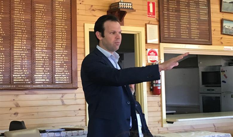 Minister Matt Canavan raises his arm and speaks to a crowd at the Hawker Sports Club.