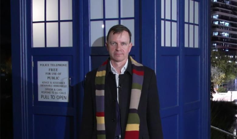 Photo of Dr Bruce Warrington in front of a Tardis post office box provided by the ABC.