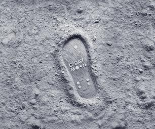 Outline of ‘flip-flop’ shoe print in the surface of the moon with text in the centre of the footprint which reads ‘G’day Moon’