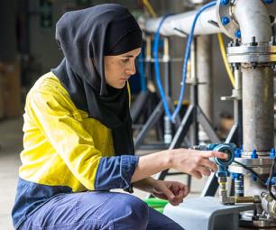 A women working in an industrial setting.