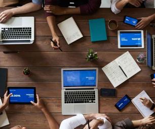 Team of professionals gathered around a table in a meeting.