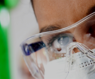 Scientist looking at test tube