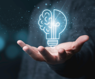 Lightbulb in shape of brain with hand underneath