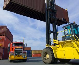 Image of a loaded container handler moving a shipping container