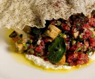 Lab grown forged cultured Japanese quail foie gras is presented on a plate in a restaurant