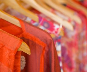 Close up image of textile clothing on clothing hangers.