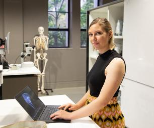A female scientist working on a laptop in a science laboratory.