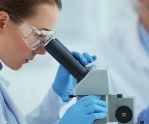 Female scientist using a microscope in a laboratory