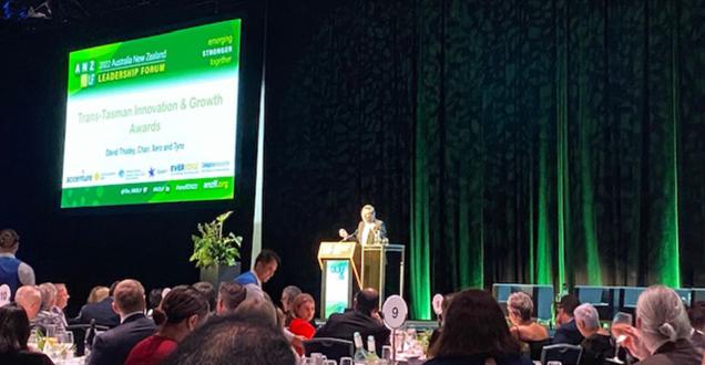An awards recipient giving a speech on stage.