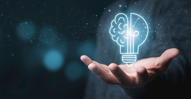 Lightbulb in shape of brain with hand underneath