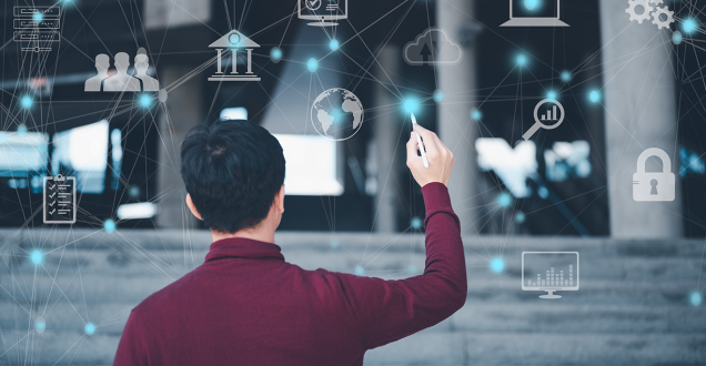 Person stands in front of virtual whiteboard and connects dots between digital symbols 