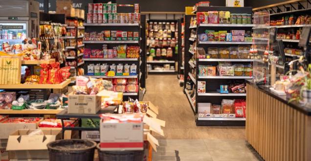 The image shows store shelves stocked with non-perishable food products.
