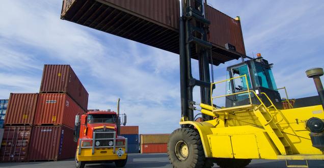 Image of a loaded container handler moving a shipping container