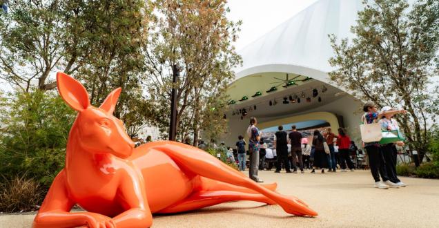 An orange statue of a kangaroo lying down outside the Australia Pavilion at the World Expo Osaka 2025.