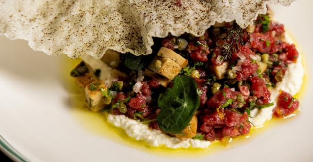 Lab grown forged cultured Japanese quail foie gras is presented on a plate in a restaurant