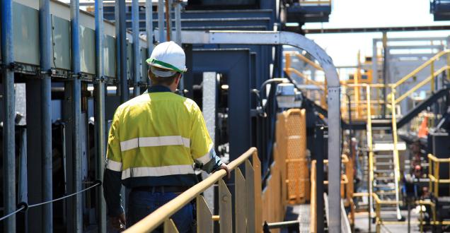 Photo of a construction worker wearing a safety uniform in industrial setting