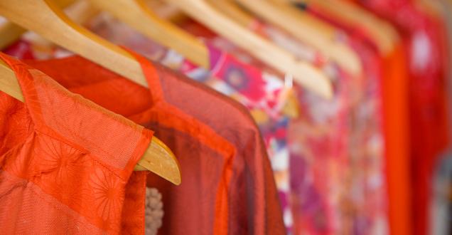 Close up image of textile clothing on clothing hangers.