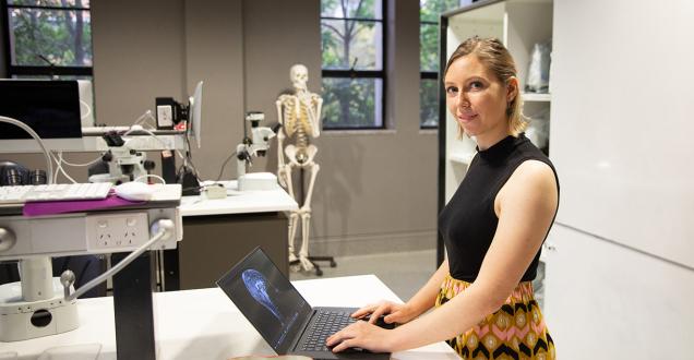 A female scientist working on a laptop in a science laboratory.