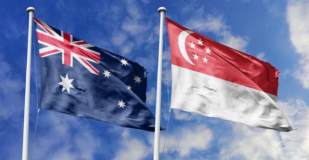 Australia and Singapore flags flying against the sky