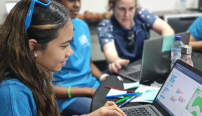 Class of First Nations students with a teacher working on laptops