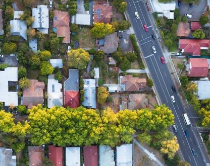 Aerial shot of houses and a road in a suburb.