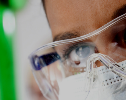Scientist looking at test tube