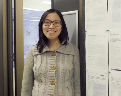 Dri Xia Hua standing at the door to her office