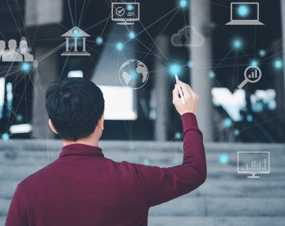 Person stands in front of virtual whiteboard and connects dots between digital symbols 