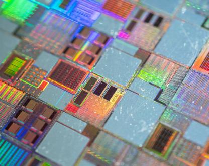 Close up image of semiconductor silicon wafer with text ‘Grant opportunity - International Partnerships in Critical Minerals Program – applications now open’. 