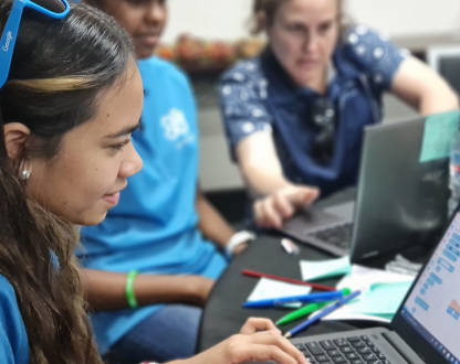 Class of First Nations students with a teacher working on laptops