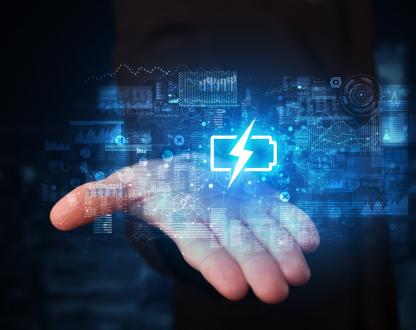 An open palm, hold a blue logo of a battery with a lightning bolt in the centre.