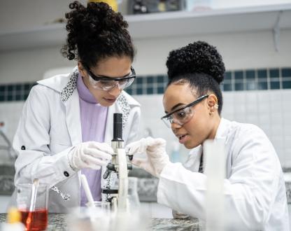 Teenage student using the microscope in the laboratory