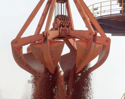 A mining bucket releases its contents