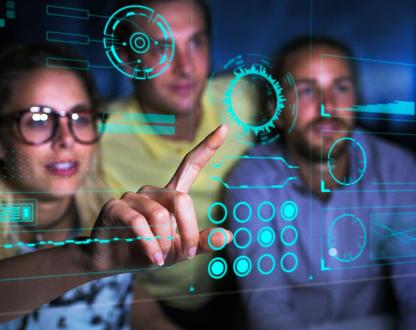 People looking at pointing to data on a screen