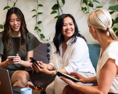 Three women from diverse backgrounds networking. 