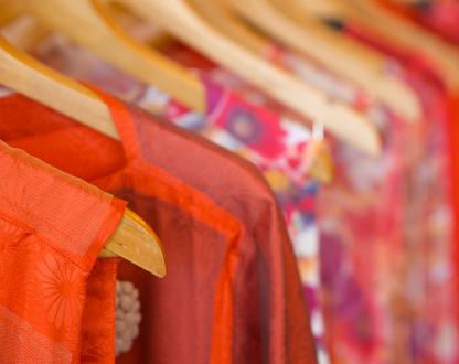 Close up image of textile clothing on clothing hangers.