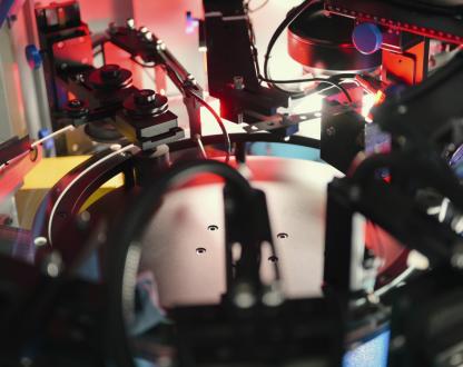 Robotic system assembles electronic components with high-speed precision, emphasising industrial automation, circuit production, and AI-driven electronics.
