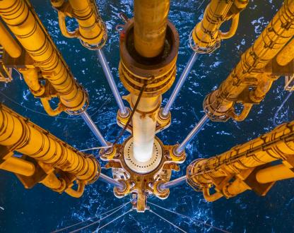 View of drilling equipment from an offshore oil and gas platform looking into the ocean