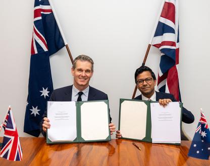 Australia’s Assistant Minister for Science, Technology and the Digital Economy, Dr Andrew Charlton MP and UK Minister for AI and Online Safety, Kanishka Narayan MP hold signed copies of the MoU.