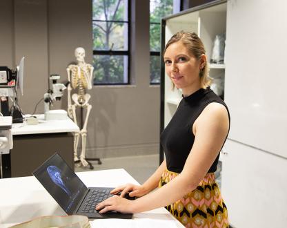 A female scientist working on a laptop in a science laboratory.